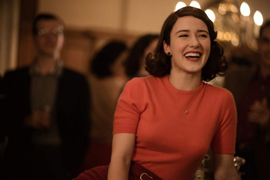 Rachel Brosnahan as Midge Maisel laughs as she enjoys a party